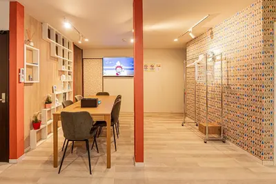 a conference room with a table and chairs and a screen at Tokyo Skytree House 3LDK, 2Bath, 8 Guests, 6min to Keisei Hikifune in Tokyo