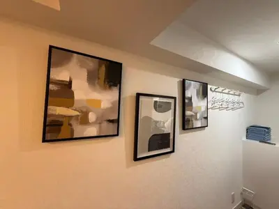 three framed pictures hanging on a wall at \u30e9\u30a4\u30aa\u30f3\u30ba\u30d7\u30e9\u30b6\u65b0\u5bbf1002 in Tokyo