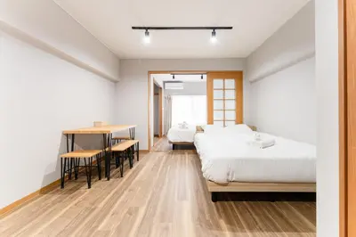 a bedroom with two beds and a table and chairs at Ohana's 2rooms Walk to Shibuya station by 8 minutes apartment studio MAX10 in Tokyo