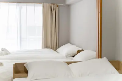 two beds in a room with a mirror at Ohana's 2rooms Walk to Shibuya station by 8 minutes apartment studio MAX10 in Tokyo