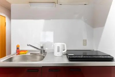 a kitchen counter with a sink and a stove at Ohana's 2rooms Walk to Shibuya station by 8 minutes apartment studio MAX10 in Tokyo