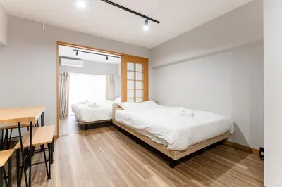 two beds in a room with a table and a desk at Ohana's 2rooms Walk to Shibuya station by 8 minutes apartment studio MAX10 in Tokyo