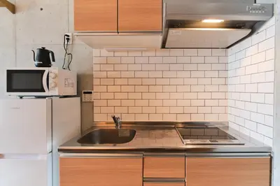 a kitchen with a sink and a refrigerator at monthly U Place Shimokitazawa in Tokyo