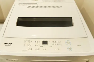 a white washing machine sitting on a counter at monthly U Place Shimokitazawa in Tokyo