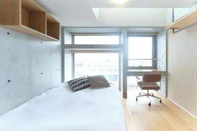 a bedroom with a bed and a desk and a chair at monthly U Place Shimokitazawa in Tokyo