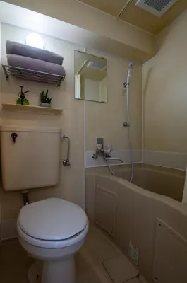 a bathroom with a toilet and a bath tub at CraftFlat Komagome 507, a compact studio at excellent location in Tokyo