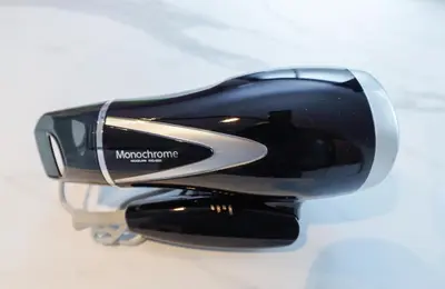 a black and silver hair drier sitting on a table at monthly TS Yoyogi in Tokyo