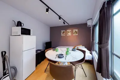 a small room with a table and a refrigerator at monthly TS Yoyogi in Tokyo