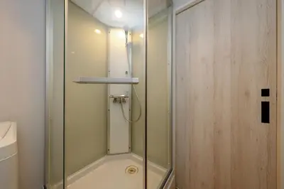 a shower with a glass door in a bathroom at monthly TS Yoyogi in Tokyo