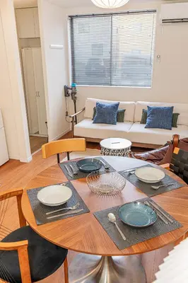 a living room with a table and a couch at KAKURE Yahiro 3-Chome New 2LDK House,Washer-Dryer & Free Parking,1 Stop to Skytree in Tokyo