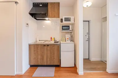 a small kitchen with a sink and a refrigerator at KAKURE Yahiro 3-Chome New 2LDK House,Washer-Dryer & Free Parking,1 Stop to Skytree in Tokyo