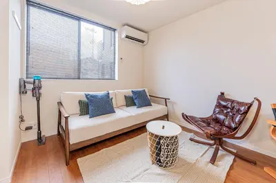 a living room with a couch and a chair at KAKURE Yahiro 3-Chome New 2LDK House,Washer-Dryer & Free Parking,1 Stop to Skytree in Tokyo