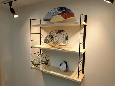 a shelf with plates on it on a wall at Stay Chill Toranomon in Tokyo