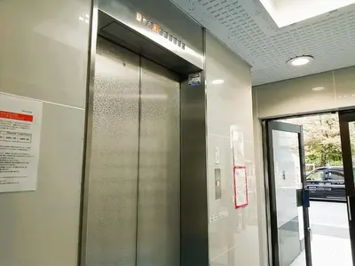 an elevator in a building with a glass door at Stay Chill Toranomon in Tokyo