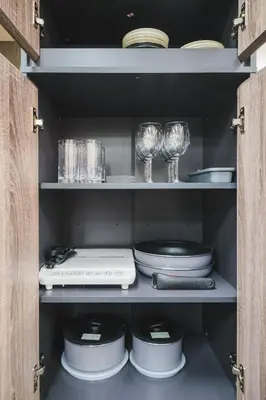a cabinet filled with plates and glasses and dishes at Stay Chill Toranomon in Tokyo