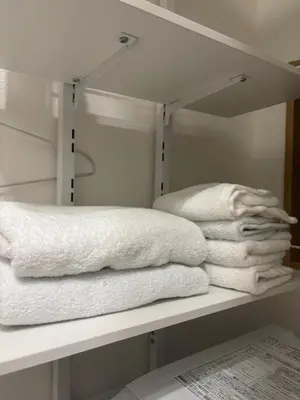 a pile of towels are sitting on a shelf at Pad Foot in Tokyo