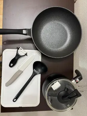 a frying pan and spatula sitting on a cutting board at Pad Foot in Tokyo