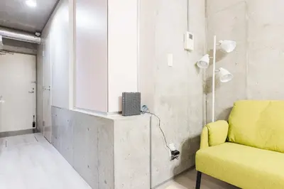 a living room with a yellow couch and a window at Apro Stay \u54c1\u5ddd\u685c\u30d2\u30eb\u30ba11 in Tokyo