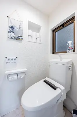 a bathroom with a white toilet and a window at SHOGUN HOTEL HORIKIRi in Tokyo