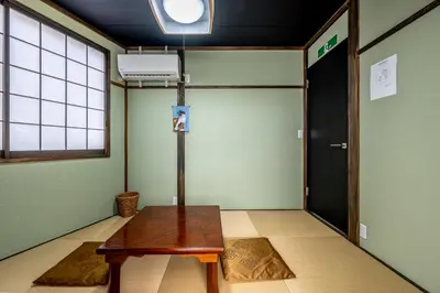a room with a wooden table and a door at SHOGUN HOTEL HORIKIRi in Tokyo