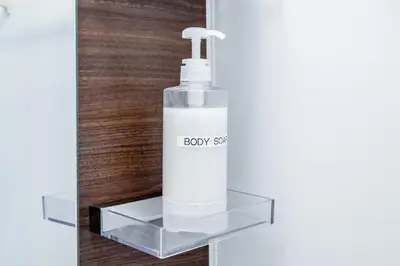 a bottle of body spray on a glass shelf at SHOGUN HOTEL HORIKIRi in Tokyo