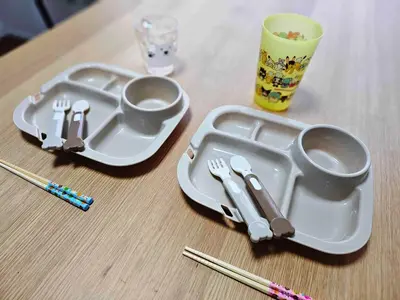 a table with two plastic plates and chopsticks and a cup at SHOGUN HOTEL HORIKIRi in Tokyo