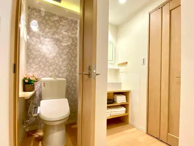a bathroom with a white toilet in a room at H-Tokyo Simple and Warm Rooms in Tokyo