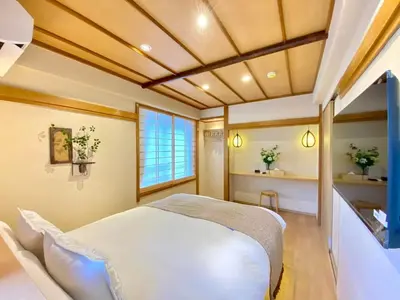 a bedroom with a white bed and a window at H-Tokyo Simple and Warm Rooms in Tokyo