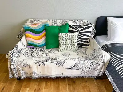 a couch with pillows on it in a room at AAt Hotel \u30a2\u30fc\u30d0\u30f3\u30cf\u30a4\u30c4\u5c0f\u83c5201 in Tokyo