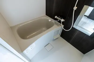 a bath tub in a small bathroom with a window at Tokyo Skytree 101 Elegance Blue Twin w Bath & WC in Tokyo
