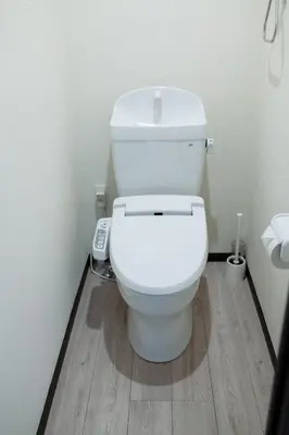 a white toilet in a bathroom with a wooden floor at Tokyo Skytree 101 Elegance Blue Twin w Bath & WC in Tokyo