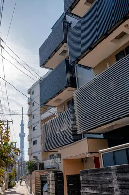 a building with balconies on the side of a street at Tokyo Skytree 101 Elegance Blue Twin w Bath & WC in Tokyo