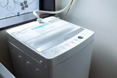 a white washing machine sitting next to a wall at Tokyo Skytree 101 Elegance Blue Twin w Bath & WC in Tokyo