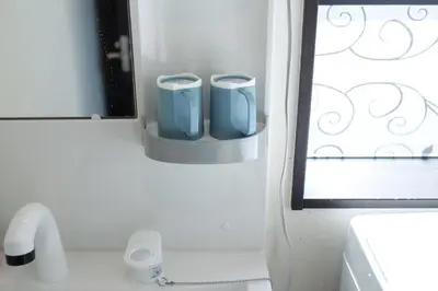 a bathroom with two blue cups on the wall at Tokyo Skytree 102 Bali-Style Double bed Bath & WC in Tokyo