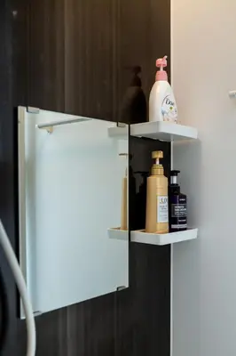 a white shelf with bottles on it in a bathroom at Tokyo Skytree 102 Bali-Style Double bed Bath & WC in Tokyo