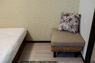 a chair with a pillow on it in a bedroom at Tokyo Skytree 102 Bali-Style Double bed Bath & WC in Tokyo