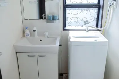 a small bathroom with a sink and a window at Tokyo Skytree 201 Elegance Blue Twin Room with Bath and WC in Tokyo