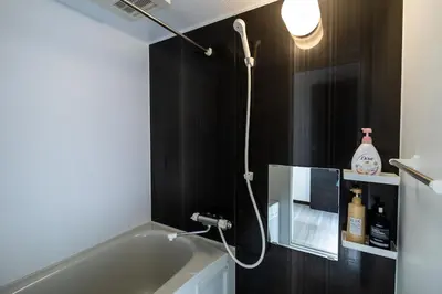 a bathroom with a bath tub and a light at Tokyo Skytree 201 Elegance Blue Twin Room with Bath and WC in Tokyo