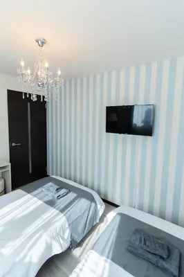a bedroom with two beds and a tv on the wall at Tokyo Skytree 301 Elegance Blue Twin Room bath WC in Tokyo