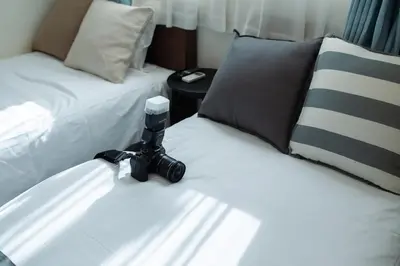 a camera sitting on a bed in a hotel room at Tokyo Skytree 301 Elegance Blue Twin Room bath WC in Tokyo