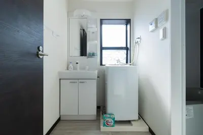 a white bathroom with a sink and a mirror at Tokyo Skytree 301 Elegance Blue Twin Room bath WC in Tokyo