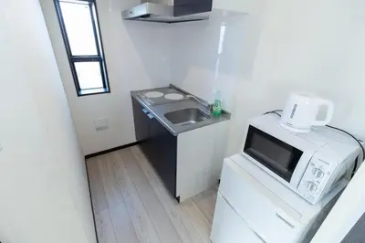 a small kitchen with a sink and a microwave at Tokyo Skytree 202 Bali-style Double Room Bathtub Private Bathroom 2 minutes to subway in Tokyo