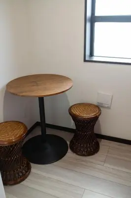 a table and two stools in a room at Tokyo Skytree 202 Bali-style Double Room Bathtub Private Bathroom 2 minutes to subway in Tokyo