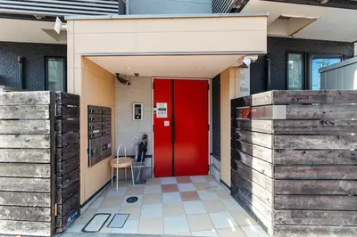 a red door in a building with wooden walls at Tokyo Skytree 202 Bali-style Double Room Bathtub Private Bathroom 2 minutes to subway in Tokyo