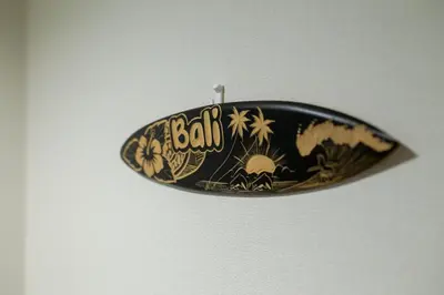 a black and gold surfboard hanging on a wall at Tokyo Skytree 302 Bali-Style Double Bath & WC in Tokyo