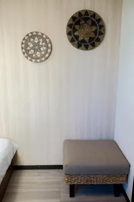 a room with a bench and two plates on the wall at Tokyo Skytree 302 Bali-Style Double Bath & WC in Tokyo