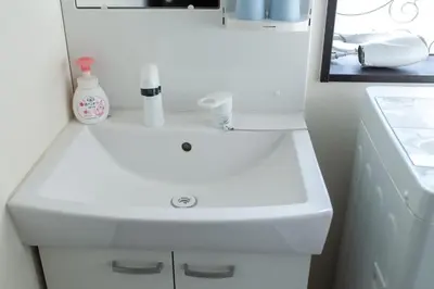 a bathroom with a white sink and a mirror at Tokyo Skytree 401 Bali-Style Twin bed Bath & WC in Tokyo