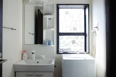 a white bathroom with a sink and a window at Tokyo Skytree 401 Bali-Style Twin bed Bath & WC in Tokyo