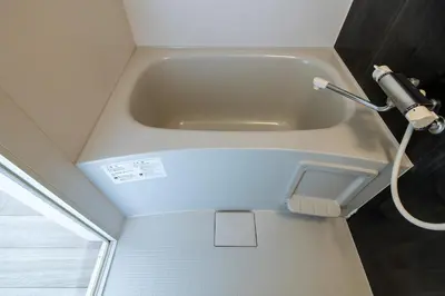 a bath tub in a bathroom with a hose at Tokyo Skytree 401 Bali-Style Twin bed Bath & WC in Tokyo