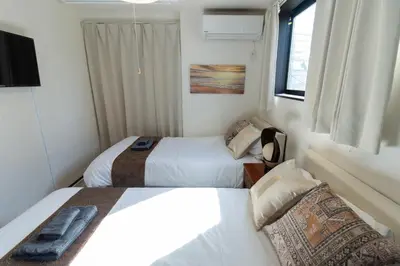 a bedroom with two beds and a television in it at Tokyo Skytree 401 Bali-Style Twin bed Bath & WC in Tokyo